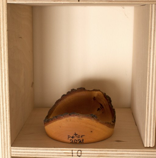 81 hand-turned wooden bowls on a home-made 9x9 compartment shelf