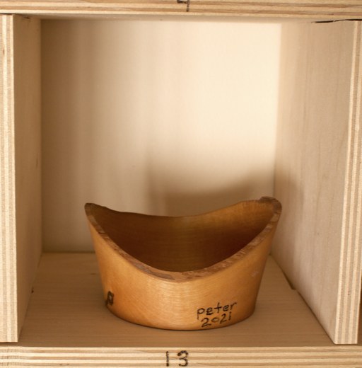 81 hand-turned wooden bowls on a home-made 9x9 compartment shelf