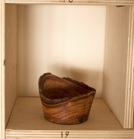 81 hand-turned wooden bowls on a home-made 9x9 compartment shelf