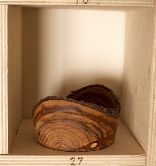 81 hand-turned wooden bowls on a home-made 9x9 compartment shelf