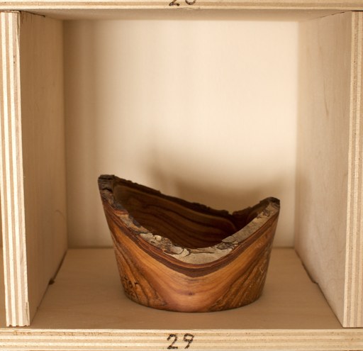 81 hand-turned wooden bowls on a home-made 9x9 compartment shelf