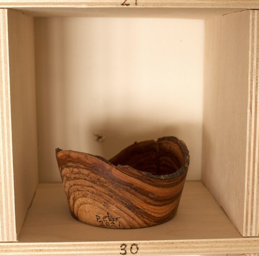 81 hand-turned wooden bowls on a home-made 9x9 compartment shelf