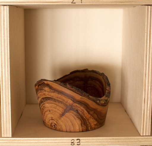 81 hand-turned wooden bowls on a home-made 9x9 compartment shelf