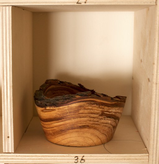 81 hand-turned wooden bowls on a home-made 9x9 compartment shelf