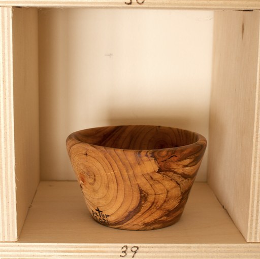 81 hand-turned wooden bowls on a home-made 9x9 compartment shelf