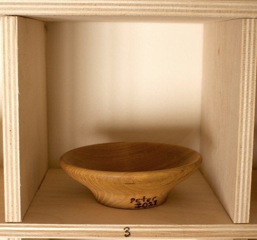 81 hand-turned wooden bowls on a home-made 9x9 compartment shelf