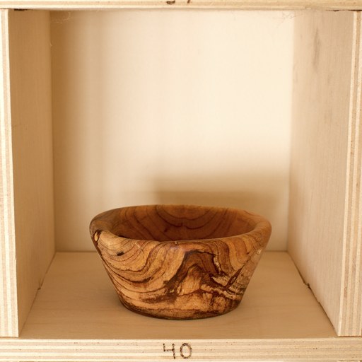 81 hand-turned wooden bowls on a home-made 9x9 compartment shelf