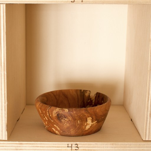 81 hand-turned wooden bowls on a home-made 9x9 compartment shelf