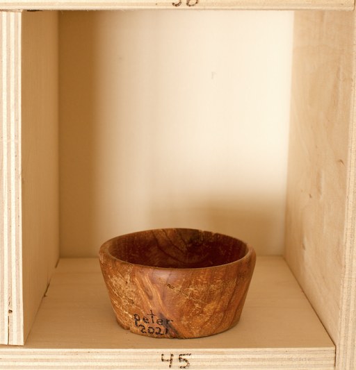 81 hand-turned wooden bowls on a home-made 9x9 compartment shelf