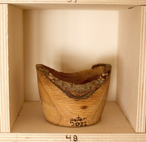 81 hand-turned wooden bowls on a home-made 9x9 compartment shelf