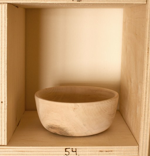 81 hand-turned wooden bowls on a home-made 9x9 compartment shelf