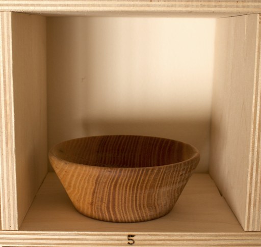 81 hand-turned wooden bowls on a home-made 9x9 compartment shelf